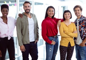Group of diverse young people standing side by side smiling